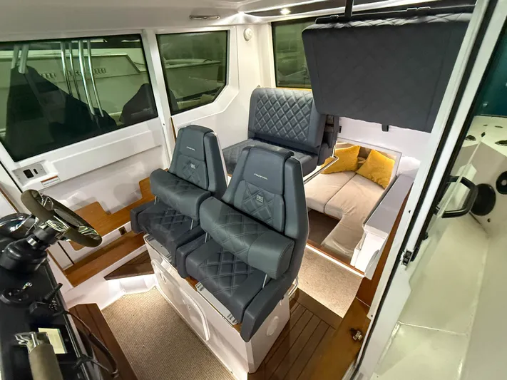 Underestimated Yacht Photos Pics Interior of 2021 Axopar 28 CABIN boat with luxurious seating and modern design.