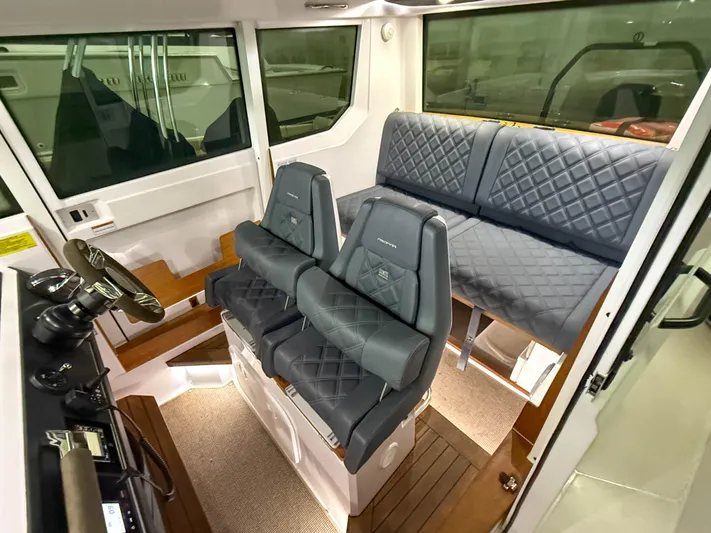 Underestimated Yacht Photos Pics Interior of 2021 Axopar 28 CABIN boat with luxurious seating and modern design.