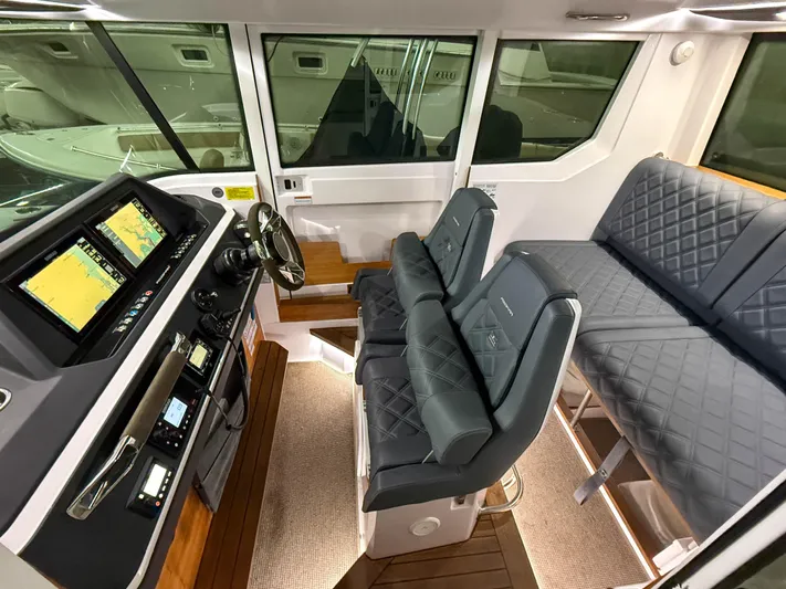 Underestimated Yacht Photos Pics Interior of 2021 Axopar 28 CABIN boat with modern dashboard and seating.