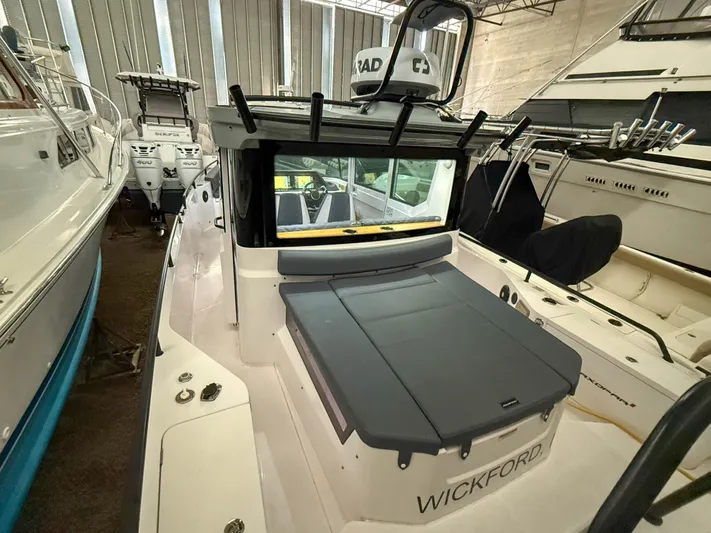Underestimated Yacht Photos Pics 2021 Axopar 28 CABIN boat in storage, featuring sleek design and modern amenities.