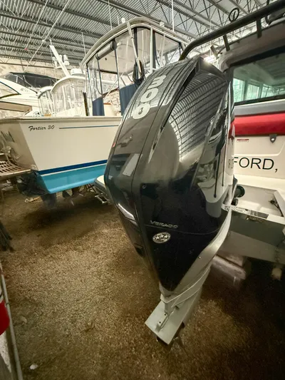 Underestimated Yacht Photos Pics 2021 Axopar 28 CABIN with powerful outboard motor in a boat storage facility.