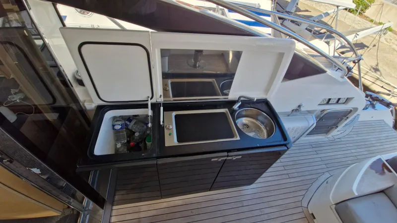  Yacht Photos Pics Outdoor kitchenette on 2012 Princess V57 yacht with sink and storage.