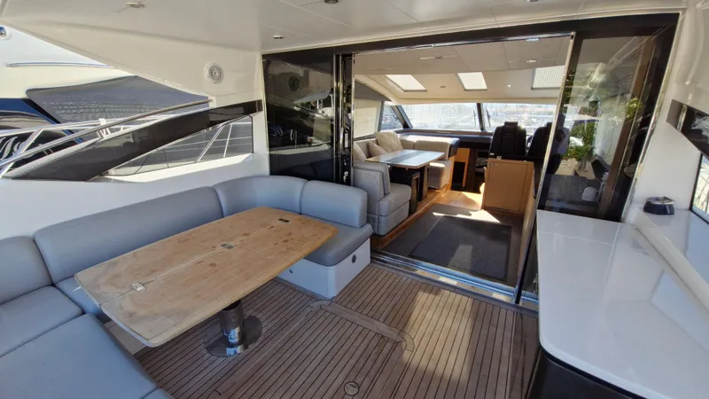  Yacht Photos Pics Luxurious 2012 Princess V57 yacht interior with spacious seating and elegant wooden table.