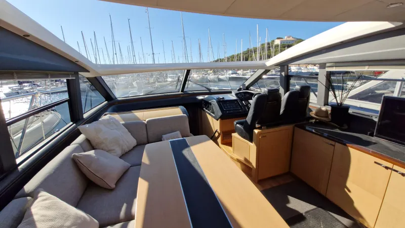 Yacht Photos Pics Luxurious interior of 2012 Princess V57 yacht with spacious seating and helm station.