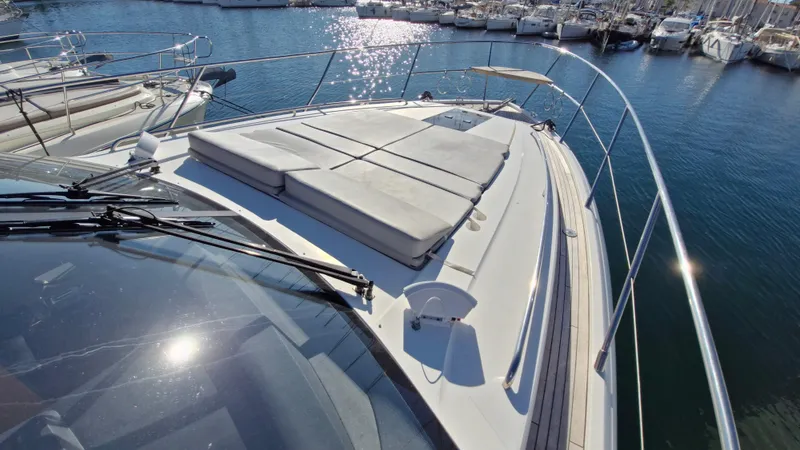  Yacht Photos Pics Luxurious 2012 Princess V57 yacht docked in a marina, featuring spacious sunbathing area.