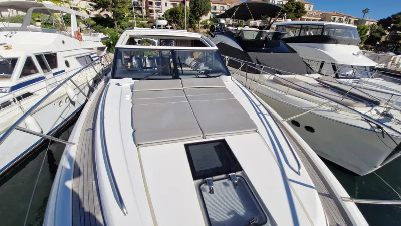  Yacht Photos Pics 2012 Princess V57 yacht docked among other luxury boats in a marina.