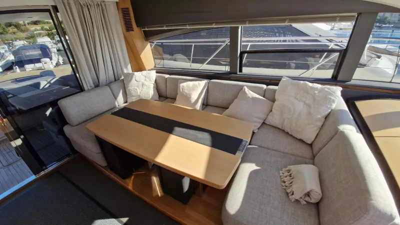  Yacht Photos Pics Luxurious interior of 2012 Princess V57 yacht with cozy seating and elegant table.