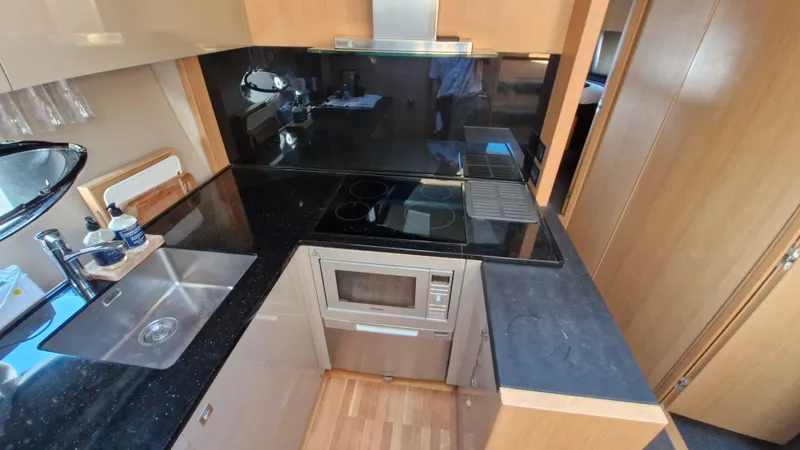  Yacht Photos Pics Modern kitchen in 2012 Princess V57 yacht with sleek appliances and black countertops.