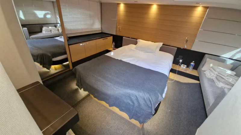  Yacht Photos Pics Luxurious cabin interior of 2012 Princess V57 yacht with cozy bed and modern decor.