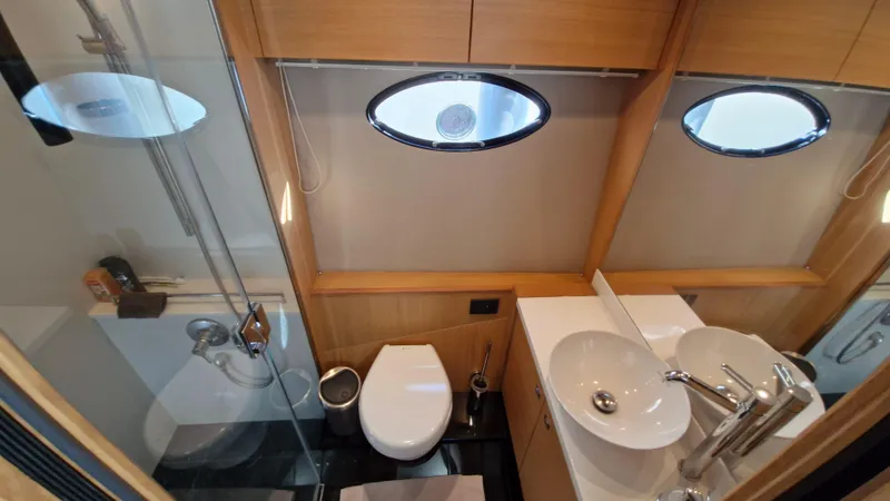  Yacht Photos Pics Luxurious bathroom in 2012 Princess V57 yacht with modern fixtures and elegant design.
