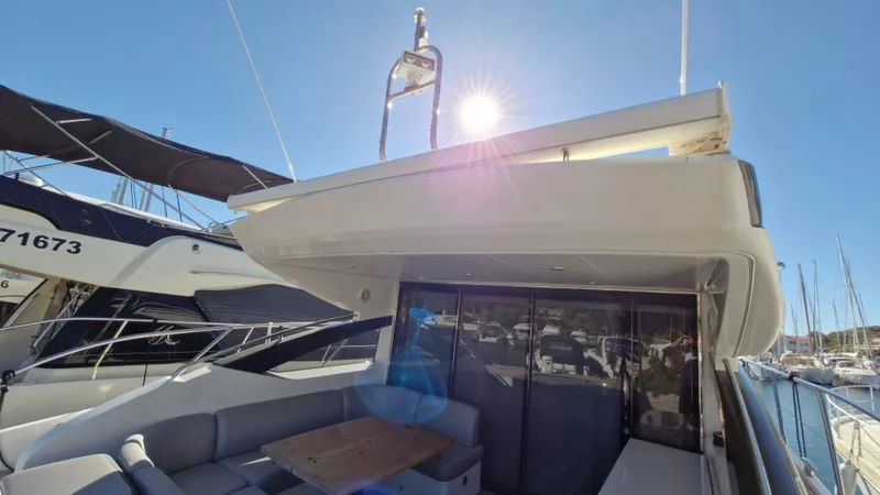  Yacht Photos Pics 2012 Princess V57 yacht with sunlit deck and marina view.