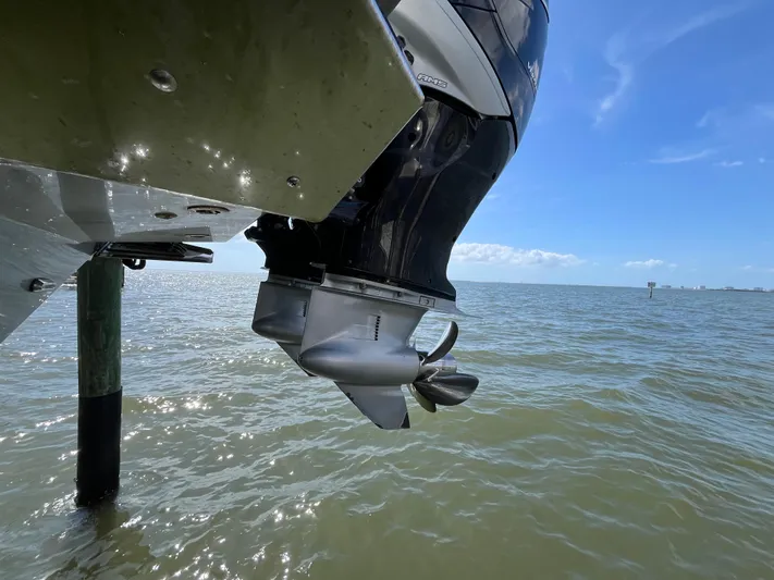  Yacht Photos Pics Outboard motor of 2022 Seapro 320 DLX boat over water under clear sky.
