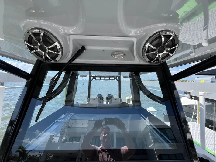  Yacht Photos Pics 2022 Seapro 320 DLX boat interior with speakers, overlooking water and dock.