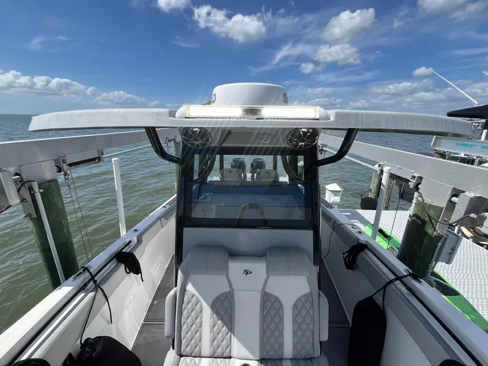  Yacht Photos Pics 2022 Seapro 320 DLX boat with sleek design, docked under a clear blue sky.