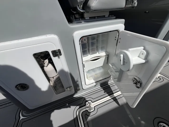  Yacht Photos Pics 2022 Seapro 320 DLX boat storage compartments with open doors, showcasing interior features.