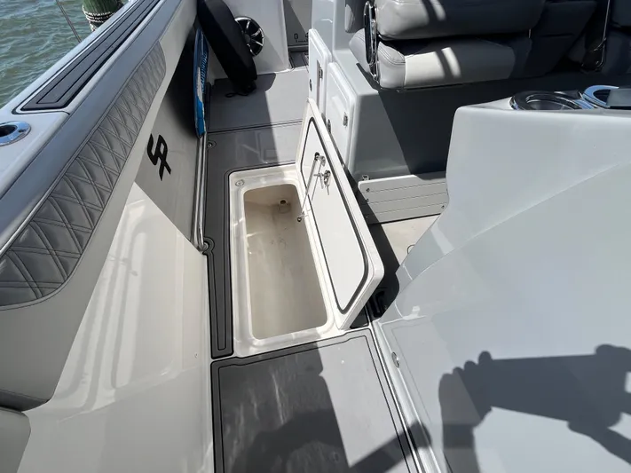  Yacht Photos Pics 2022 Seapro 320 DLX boat interior with open storage compartment and seating.