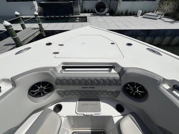  Yacht Photos Pics 2022 Seapro 320 DLX boat interior with speakers and seating, docked at a marina.