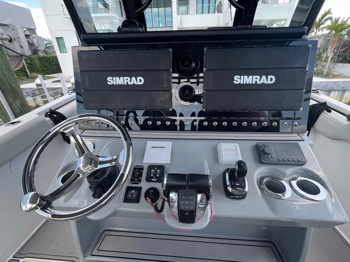  Yacht Photos Pics 2022 Seapro 320 DLX boat dashboard with dual Simrad displays and modern controls.