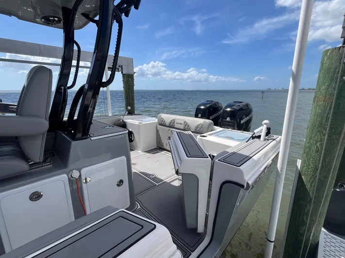  Yacht Photos Pics 2022 Seapro 320 DLX boat docked by the sea, featuring dual engines and spacious seating.