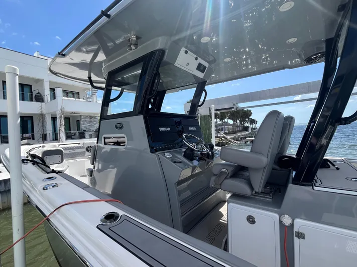  Yacht Photos Pics 2022 Seapro 320 DLX boat interior with modern helm and waterfront view.