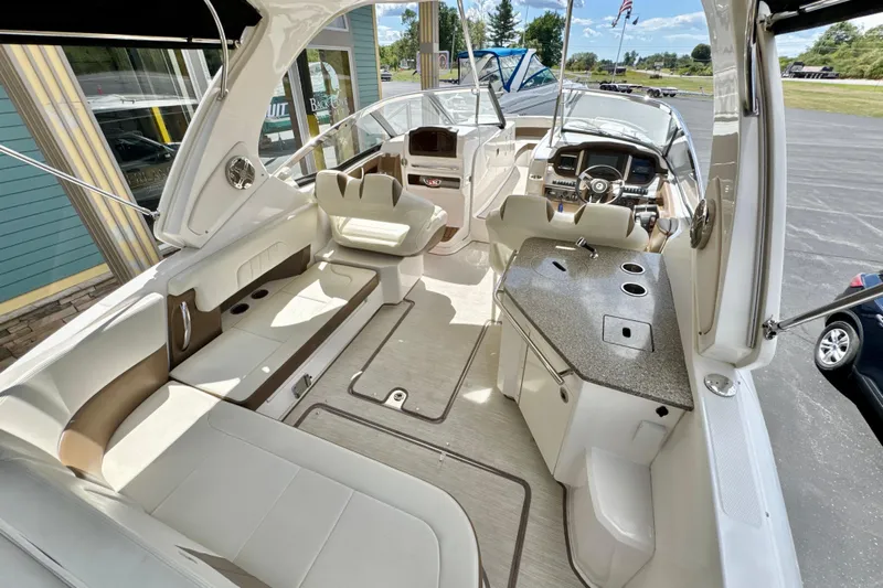  Yacht Photos Pics 2017 Chaparral 337 SSX boat interior with seating, helm, and kitchenette.