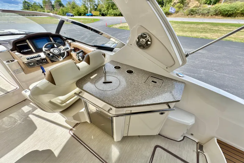  Yacht Photos Pics 2017 Chaparral 337 SSX boat interior with helm and kitchenette area.