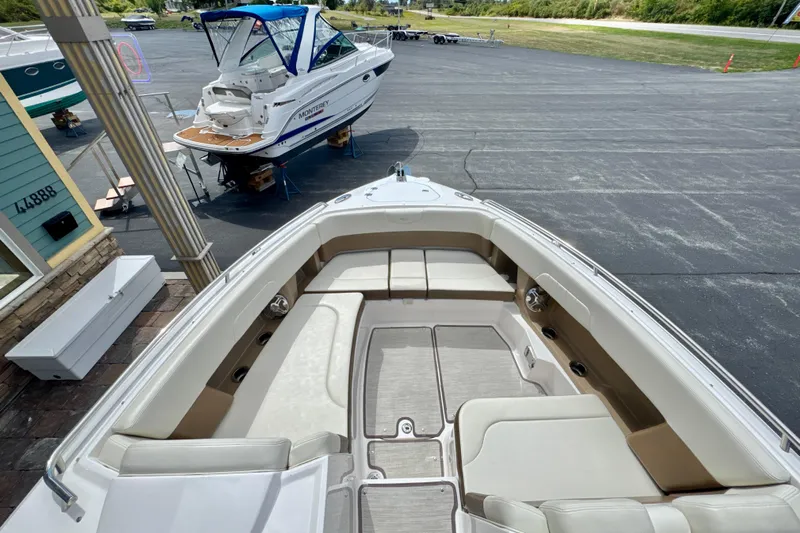  Yacht Photos Pics 2017 Chaparral 337 SSX boat interior with spacious seating, docked near another boat.