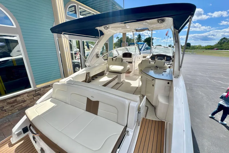  Yacht Photos Pics 2017 Chaparral 337 SSX boat with spacious seating and sleek design under a blue canopy.