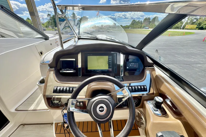  Yacht Photos Pics 2017 Chaparral 337 SSX boat dashboard with steering wheel and navigation screens.