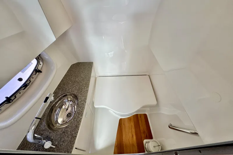  Yacht Photos Pics 2017 Chaparral 337 SSX boat bathroom with sink, countertop, and wooden flooring.