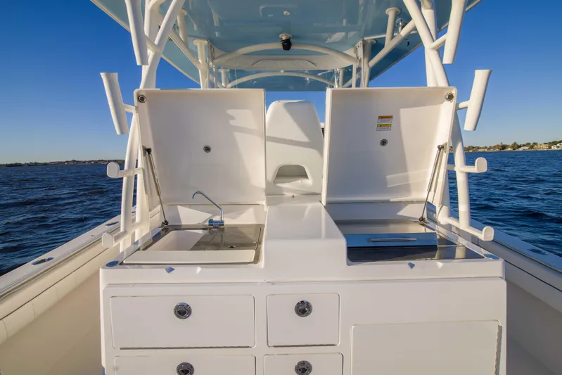 Wound Up II Yacht Photos Pics 2016 Regulator 41 boat with open storage compartments on deck, ocean background.