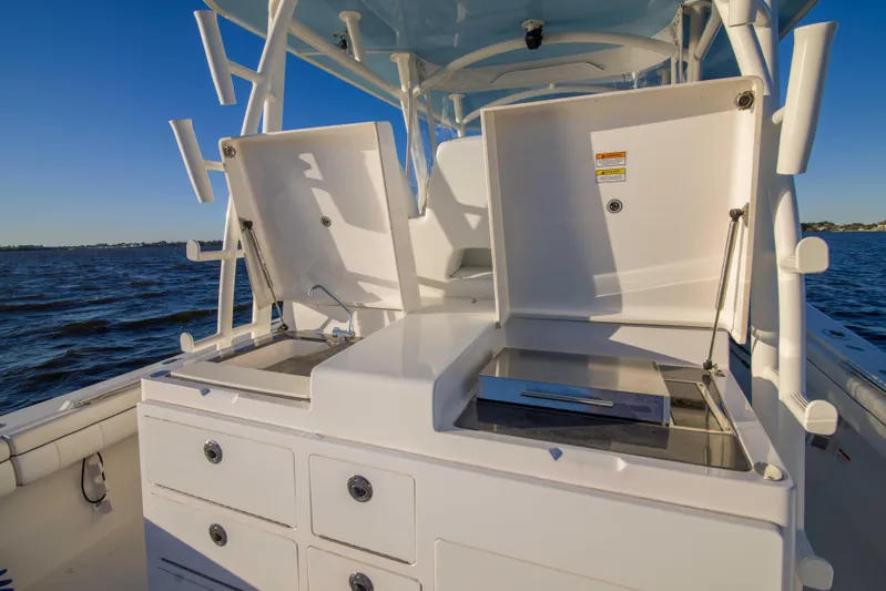 Wound Up II Yacht Photos Pics 2016 Regulator 41 boat with open storage compartments on deck, ocean view.