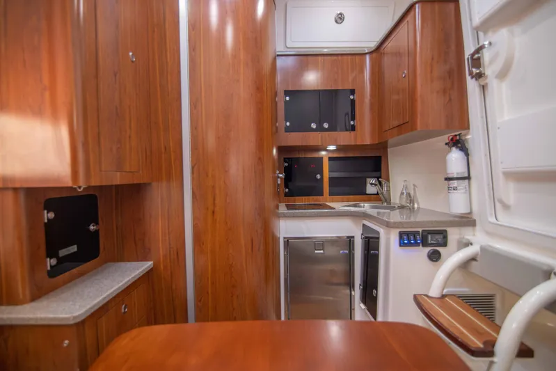 Wound Up II Yacht Photos Pics Luxurious 2016 Regulator 41 yacht interior with wood cabinetry and modern kitchen amenities.