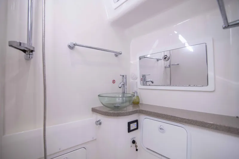 Wound Up II Yacht Photos Pics Luxurious bathroom interior of 2016 Regulator 41 boat with modern fixtures and glass sink.