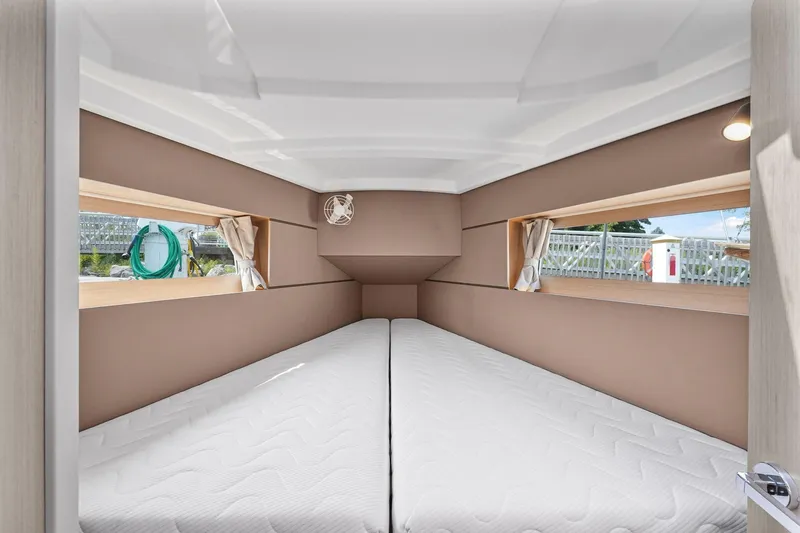 Eugenia Yacht Photos Pics Interior cabin of 2021 Beneteau Oceanis 35.1 yacht, featuring twin beds and side windows.