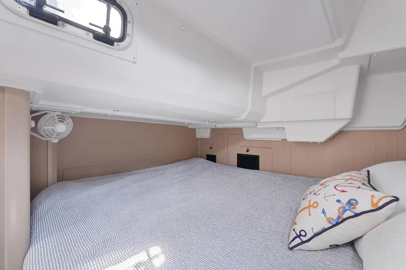 Eugenia Yacht Photos Pics Cozy cabin interior of 2021 Beneteau Oceanis 35.1 sailboat with nautical-themed pillow.