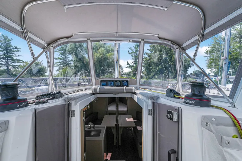 Eugenia Yacht Photos Pics 2021 Beneteau Oceanis 35.1 yacht cockpit with canopy and interior view.