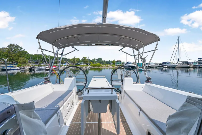 Eugenia Yacht Photos Pics 2021 Beneteau Oceanis 35.1 sailboat cockpit with dual steering wheels in a marina setting.
