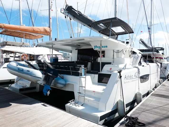 Pegasus Yacht Photos Pics 2022 Fountaine Pajot Astrea 42 catamaran docked, featuring sleek design and modern amenities.