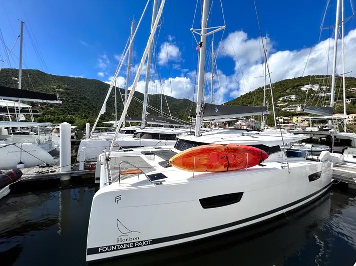 Pegasus Yacht Photos Pics 2022 Fountaine Pajot Astrea 42 catamaran docked, featuring sleek design and vibrant kayak on deck.