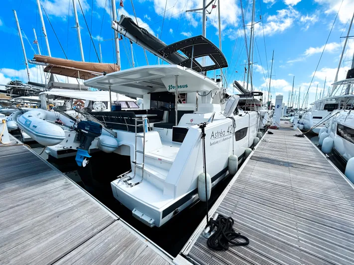 Pegasus Yacht Photos Pics Fountaine Pajot Astrea 42 catamaran docked at marina, 2022 model, clear blue sky.