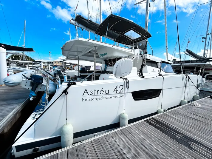 Pegasus Yacht Photos Pics 2022 Fountaine Pajot Astrea 42 catamaran docked at marina under clear blue sky.