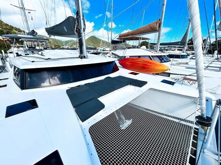 Pegasus Yacht Photos Pics 2022 Fountaine Pajot Astrea 42 catamaran docked, featuring spacious deck and vibrant kayak.