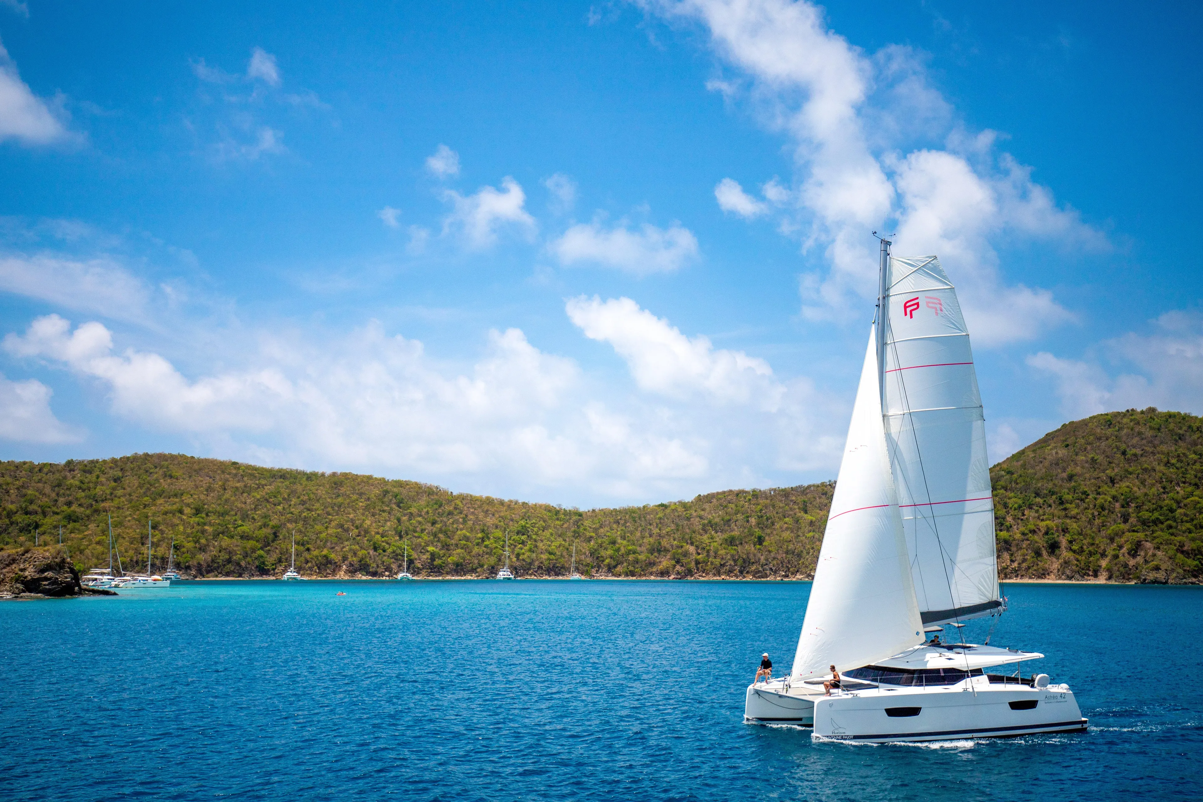 Pegasus Yacht Photos Pics 2022 Fountaine Pajot Astrea 42 sailing in clear blue waters under a sunny sky.