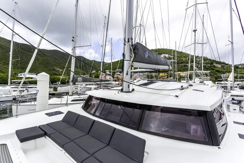 Pegasus Yacht Photos Pics 2022 Fountaine Pajot Astrea 42 catamaran docked in a scenic marina.