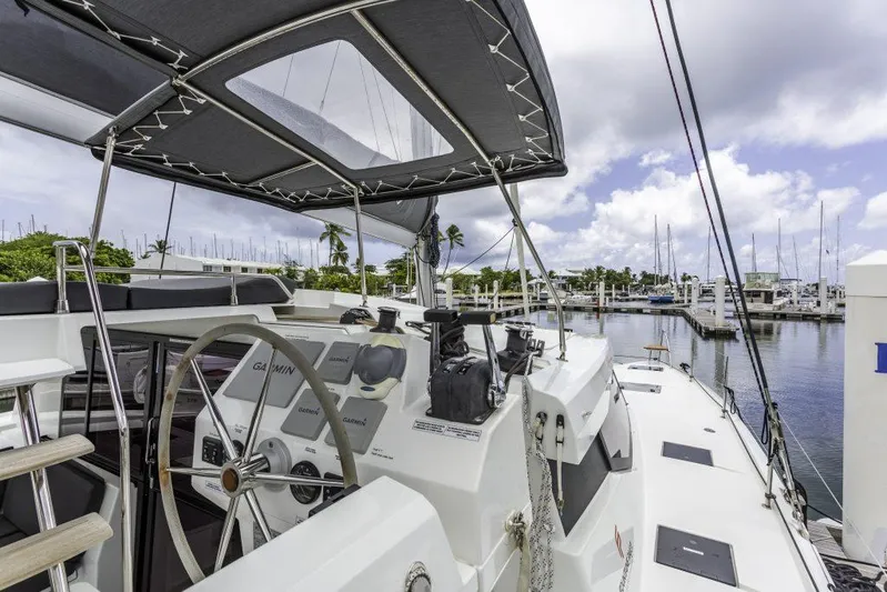 Pegasus Yacht Photos Pics 2022 Fountaine Pajot Astrea 42 catamaran docked at marina, featuring helm and canopy.