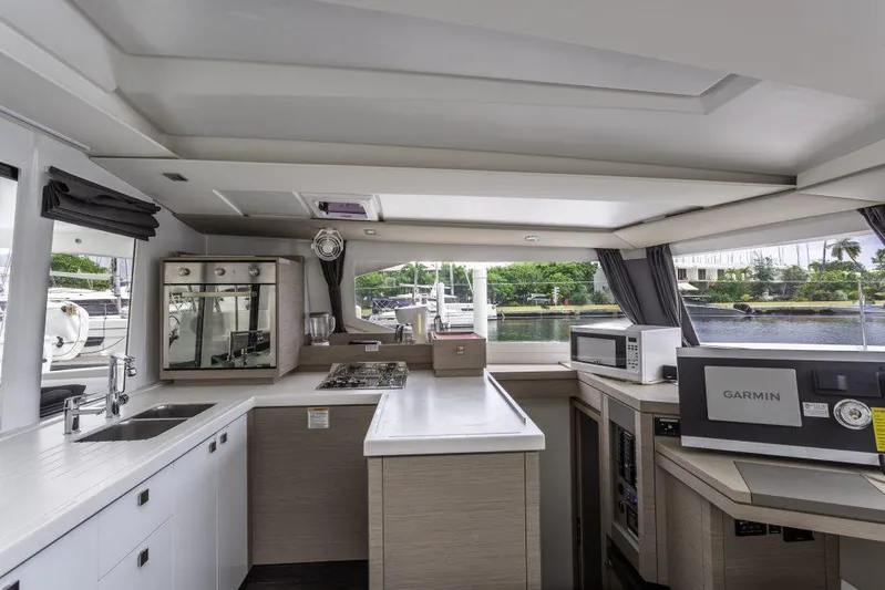 Pegasus Yacht Photos Pics Modern kitchen interior of 2022 Fountaine Pajot Astrea 42 catamaran, featuring sleek design and appliances.