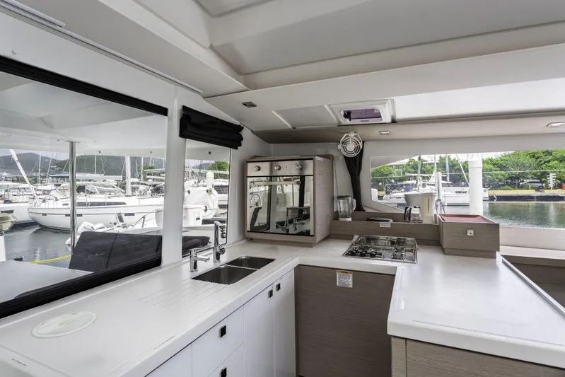 Pegasus Yacht Photos Pics Modern kitchen interior of 2022 Fountaine Pajot Astrea 42 yacht, featuring sleek countertops and appliances.