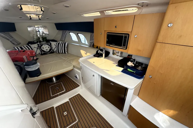  Yacht Photos Pics Luxurious interior of 2014 Intrepid 400 Cuddy boat with kitchenette and seating area.