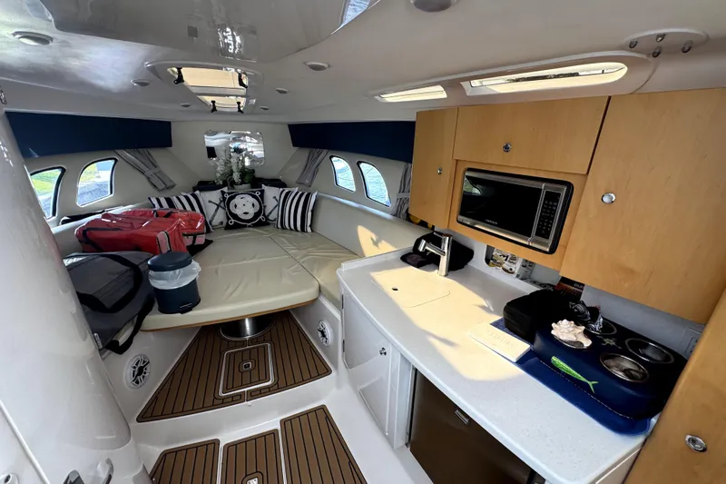  Yacht Photos Pics Interior of 2014 Intrepid 400 Cuddy boat with kitchenette and seating area.